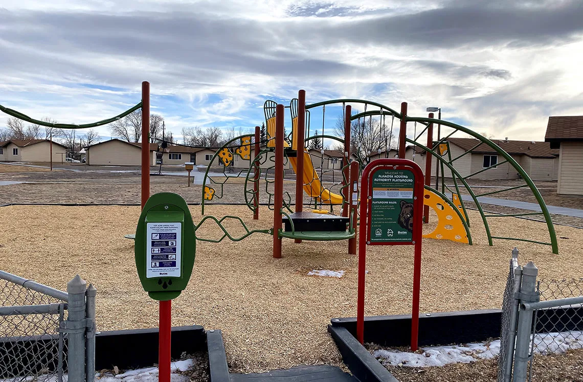 Playground signage and hand sanitizer station at Alamosa Housing Authority in Alamosa, CO